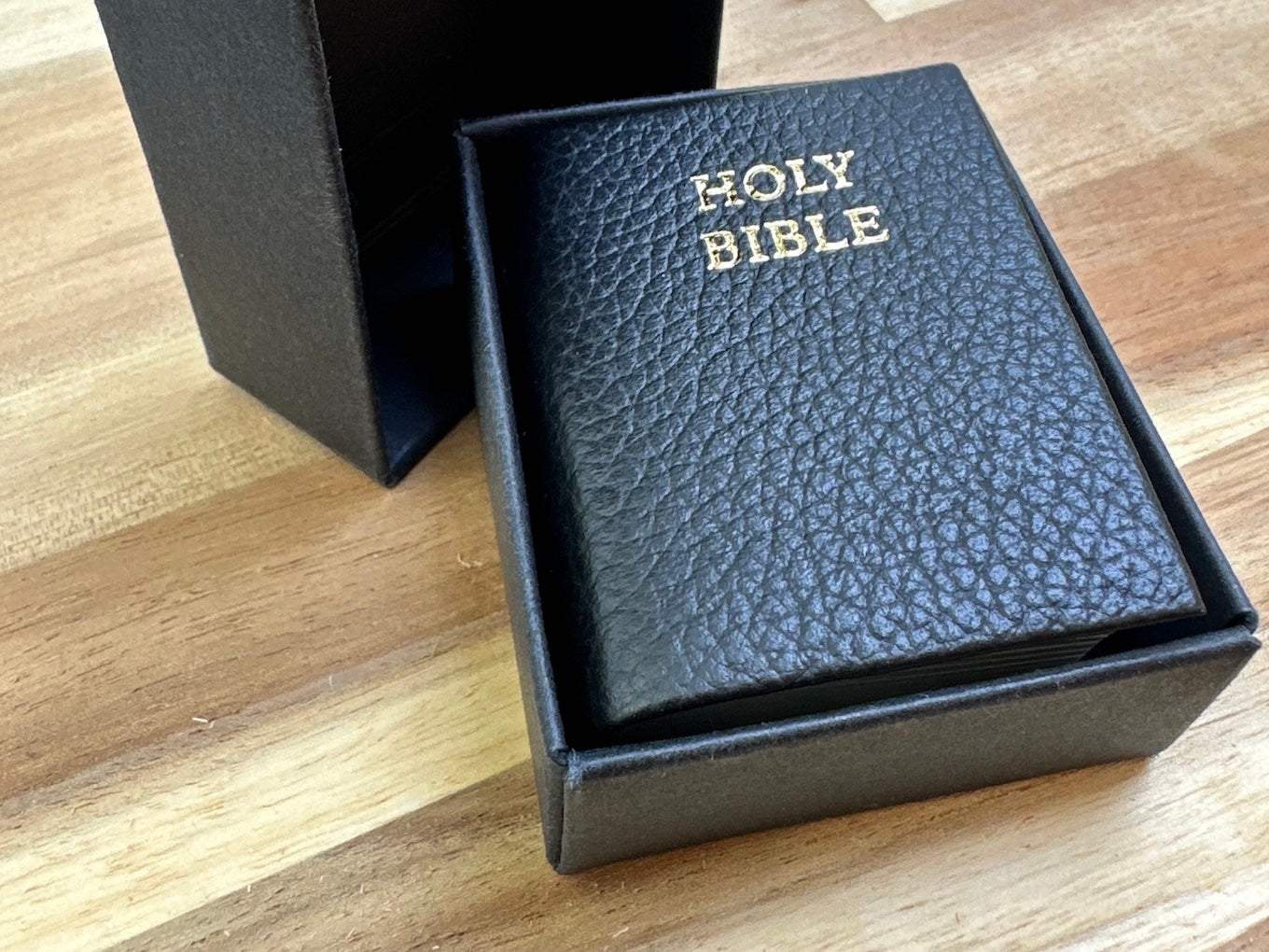 Tiny Bible comes in this snug, unmarked black box 